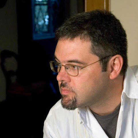 Gilson Schachnik in a white collared shirt from the side