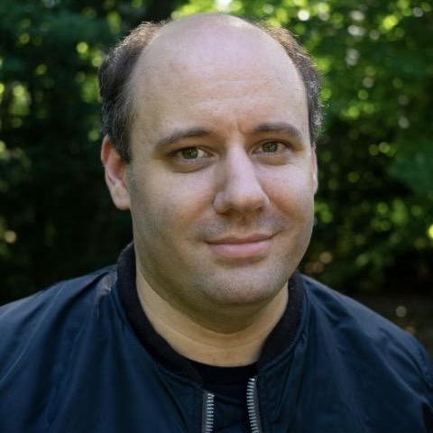 Headshot of Ryan Page outside in front of trees