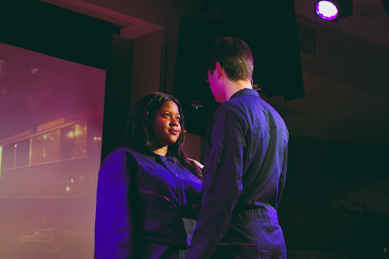two people on stage talking to each other