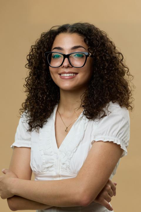 Ambar Perez poses in a white shirt with glasses